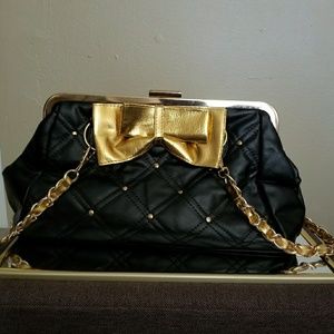 Black bag with gold bowtie